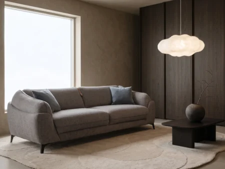 Dienne Dune sovesofa i mørk grå med unikt og luksuriøst design, stylet i et rom med maskulin interiørstil.